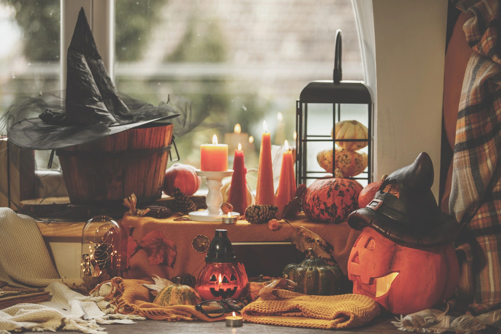 Autumn window corner with lit candles and seasonal decor