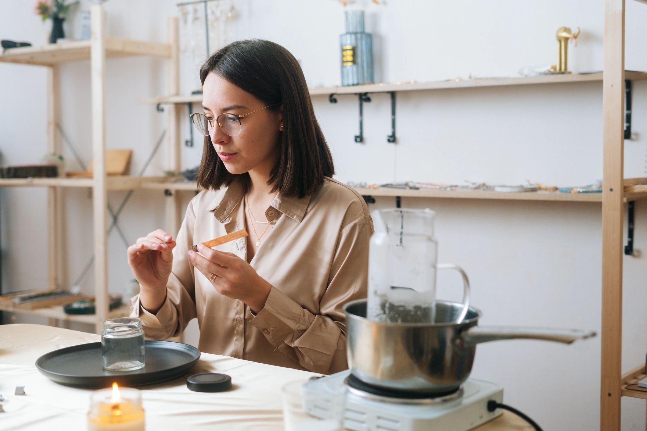 Artisan creating a candle wick at a workshop