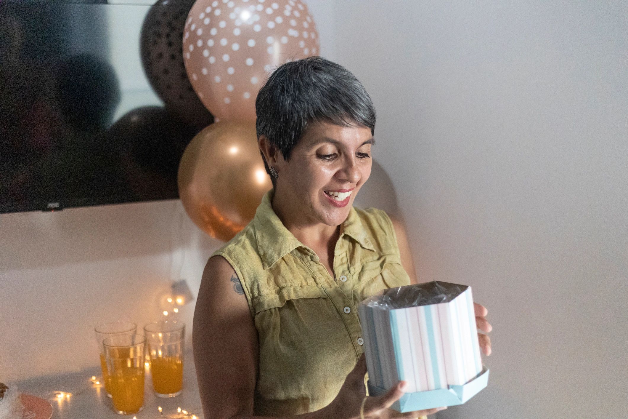 Portrait of a woman opening a gift box