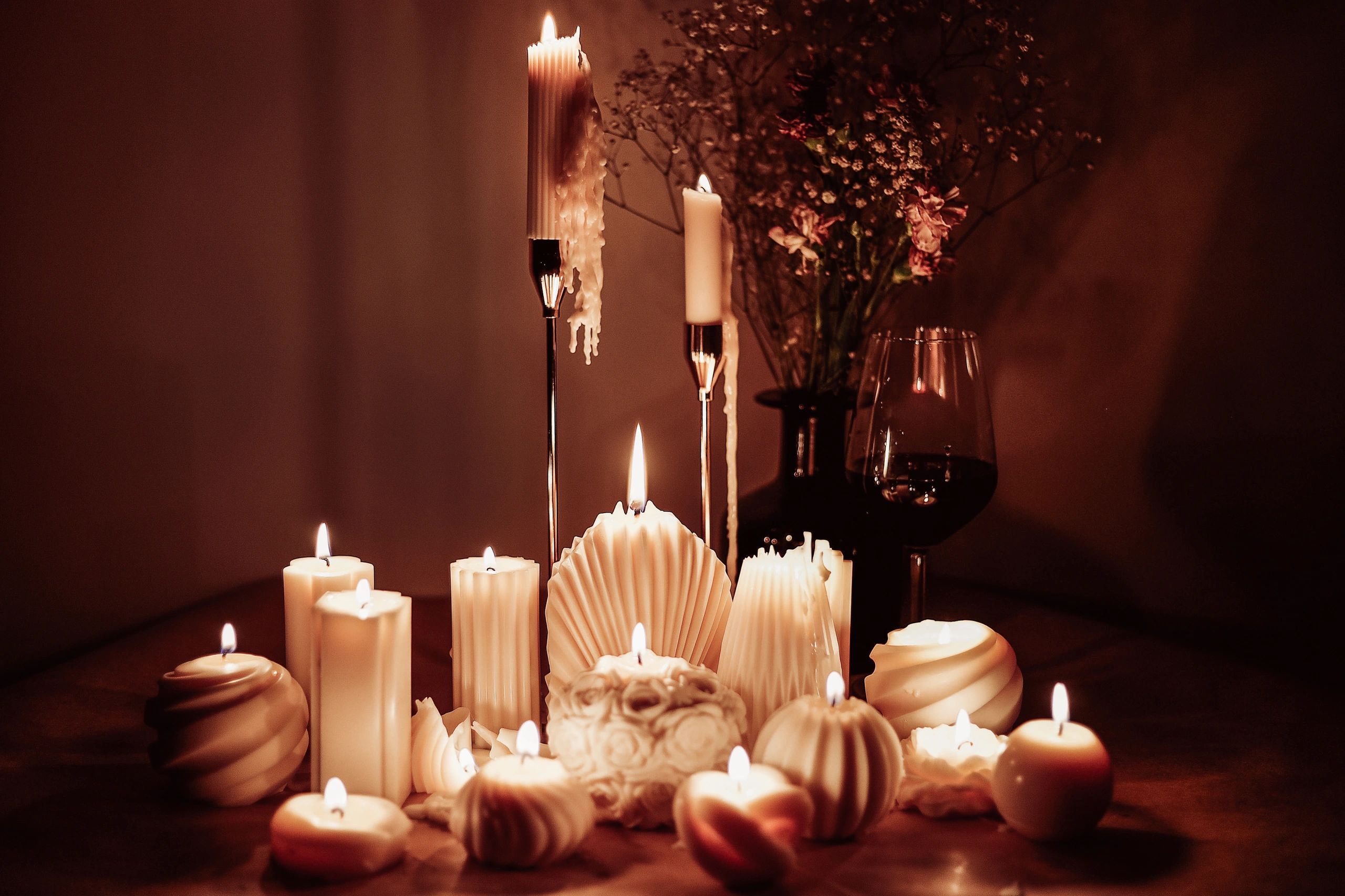 White candles arranged on a table for cozy decor